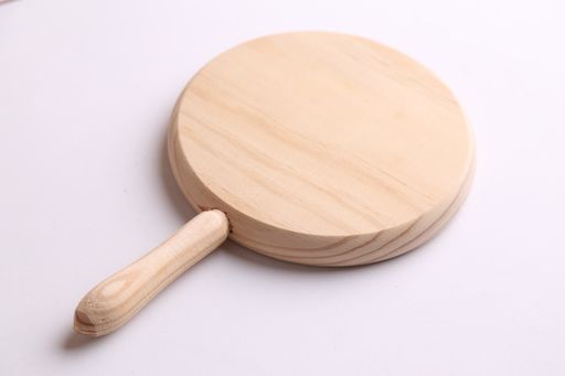 A closeup shot of a round wooden board on a white background