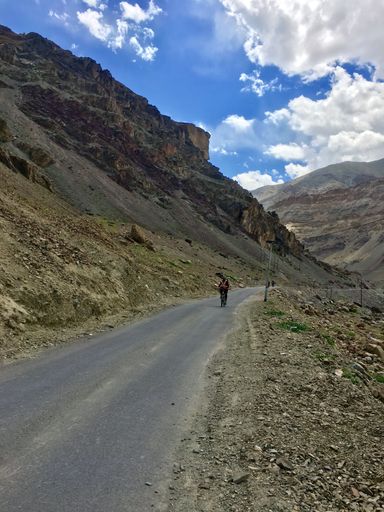 A road at the foot of a bare mountain in Ladakh, India