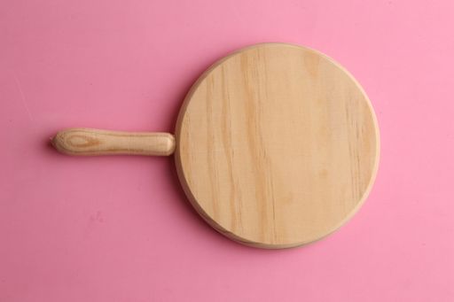 The new wooden cutting board on the pink surface