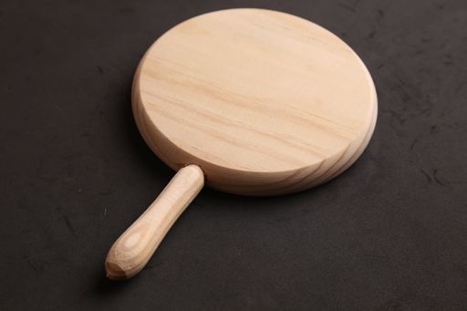 A closeup shot of a chopping board on a black surface