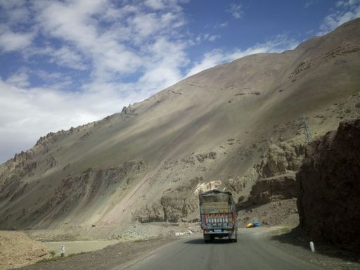 Indian lorry truck on road in the Himalayas near Tanglang la Pass - Himalayan mountain pass on the Leh-Manali highway. Ladakh, India