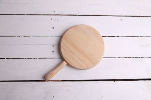 A high angle shot of a wooden cutting board isolated on a white wooden surface