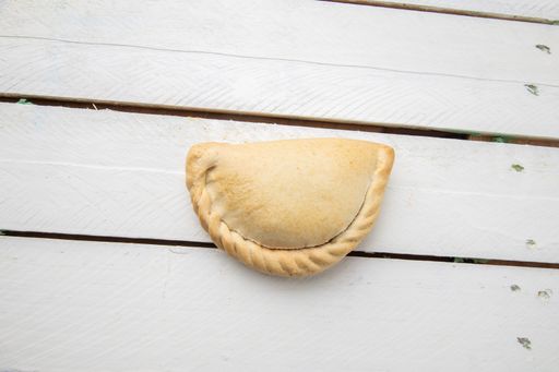 A top view closeup of a delicious empanada on a table