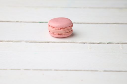 A closeup shot of a sweet and delicious pink macaroon cookie