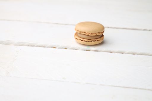 The sweet and  delicious brown macaroon cookies on the wooden surface