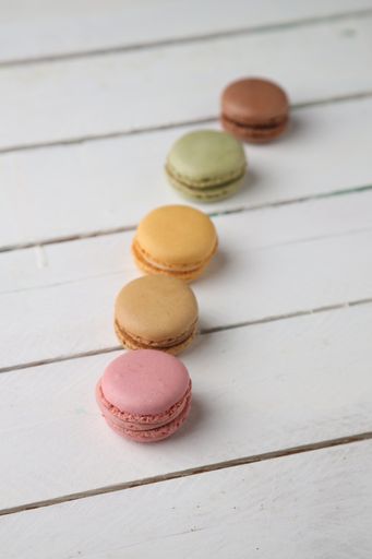 A closeup shot of the sweet and colorful macaroon cookies isolated on a white background