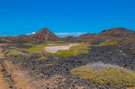 A beautiful landscape with hills and rocks under a blue sky
