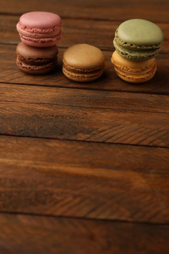 A closeup shot of delicious macarons on a wooden surface