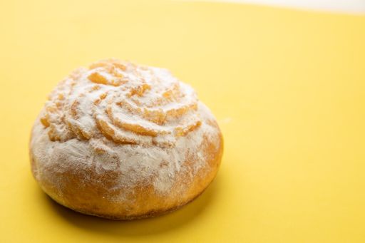 A closeup shot of a  delicious dessert of sweet coconut cake isolated on a yellow background