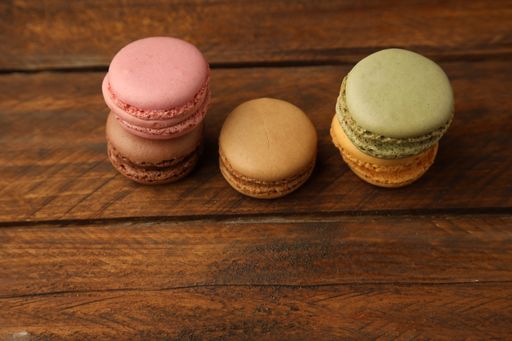 A closeup shot of delicious macarons on a wooden surface