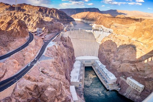 A high-angle shot of a  sunset at the Hoover Dam from the Memorial bridge