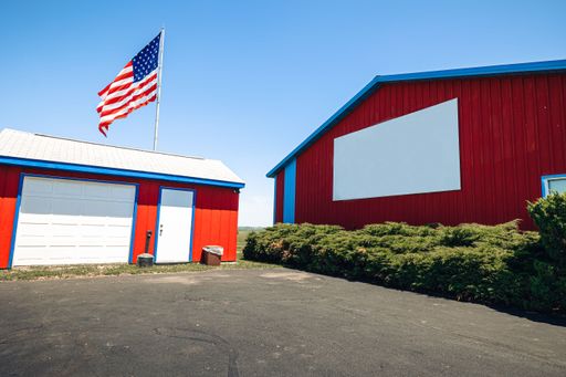 An automatic controlled poultry shed with waving American flag on the blue sky
