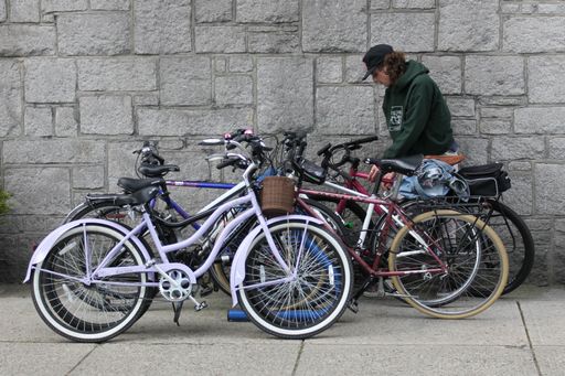 A young man and bunch of bicycles in downtown Vancouver, British Columbia, Canada