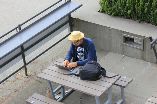 A Man working with laptop computer in downtown Vancouver, British Columbia, Canada