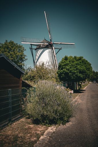 A vertical shot of old windmill by the road in Braunsmuhle, Germany