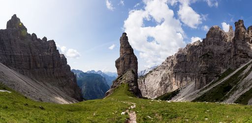 A beautiful panoramic view of rocky mountains under the blue cloudy sky