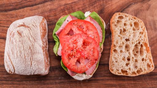 A top view of sandwich on Ciabatta bread on wooden table