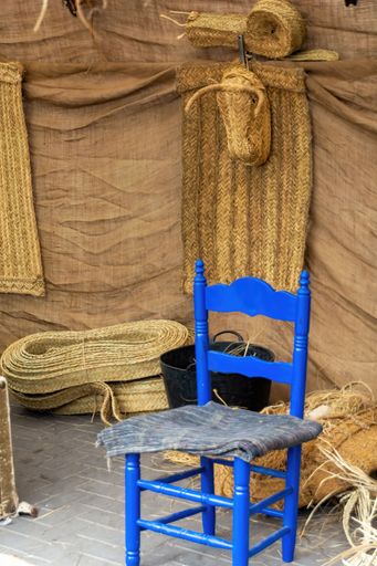 A blue chair in a traditional wicker artist workshop