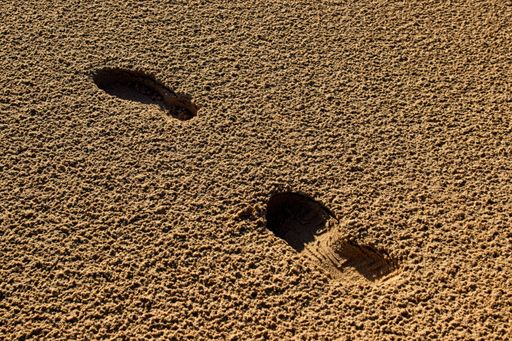 Footsteps in the sand, texture of sand