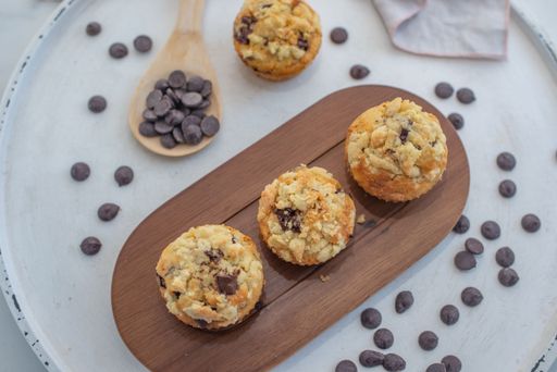 A closeup shot of sweet homemade chocolate muffins with streusel and cream