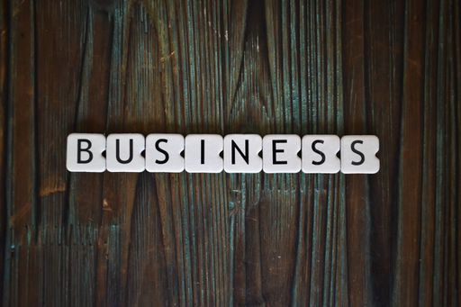 The word business written with white plastic letters on a wooden surface
