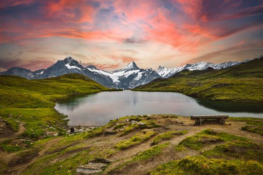 A breathtaking view of a lake surrounded by mountains at scenic sunset in Switzerland