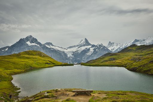 A mesmerizing view of a lake surrounded by mountains in Switzerland