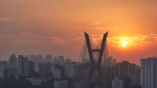 The Octavio Frias de Oliveira bridge in Sao Paulo, Brazil against orange sunset sky