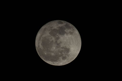 A closeup of the fool moon at night with black background