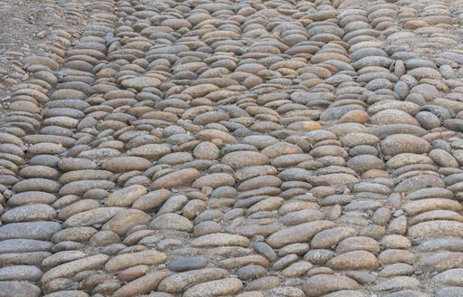 A high angle shot of a patway designed with stones captured during the daytime