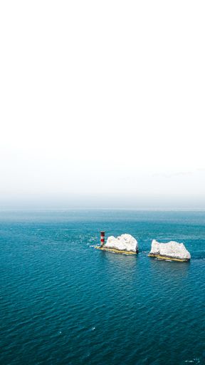 A vertical shot of the needles on the Isle of Wight in the United Kingdom with a white background