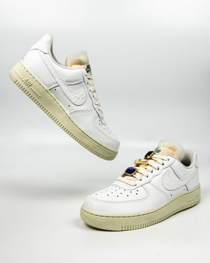A vertical shot of white Nike Air Force 1 shoes on white background