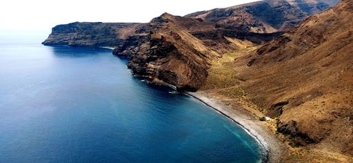 Magical seascape with coastal volcanic hills and blue wavy water in  La Gomera, Canary Islands, Spain.