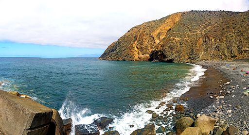 Magical seascape with volcanic hills and blue wavy water in San Sebastian de la Gomera, Canary Islands, Spain.