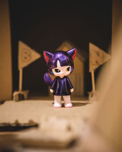 A Pop Mart x Yosuke Ueno toy figurine of Iggy the Kit on a wooden surface