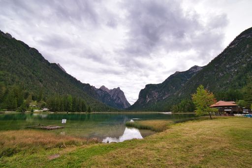 A scenic view of the Lake Misurina and Dolomites mountain landscape in Italy on a cloudy day