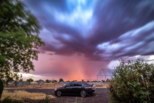 A View toward Castle Court Park of Monsoon Weather and Lightening with car in foreground