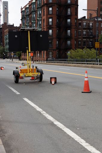 A road work sign with traffic cones
