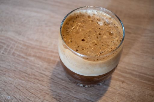 A top view of an ice latte in the glass cup on the table