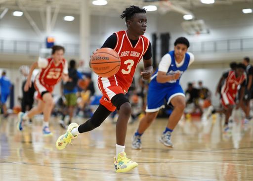 A black young boy holding and ready to pass the ball