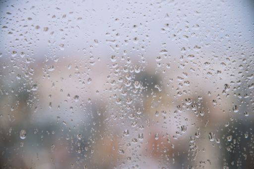 A closeup shot of raindrops on the window on a rainy weather