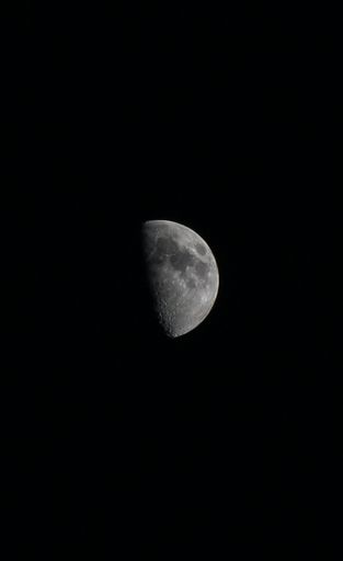 The lunar eclipse super full crescent moon against a dark sky