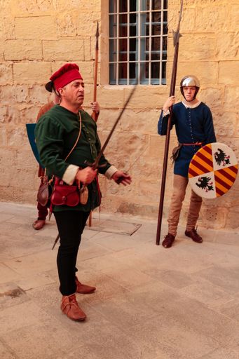 A nobleman Francesco Gatto demonstrating his weapons to an audience in a reenactment of 15th century life at Mdina, Malta, Mediterranean
A tour guide,