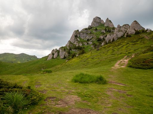A scenic view of the Ciucas Mountains in Romania under a cloudy day