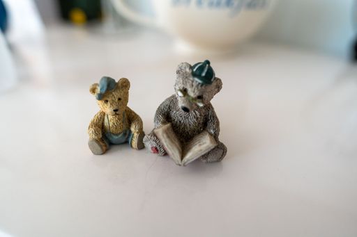 A closeup shot of two bear sculptures on the table