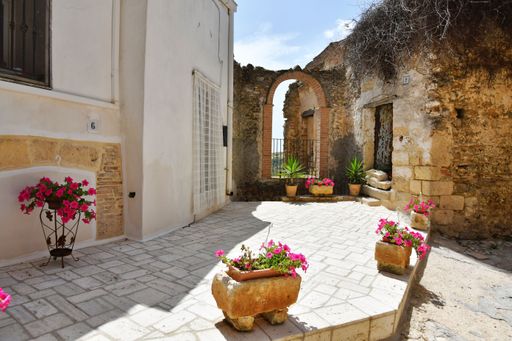 A small street between the old houses of Irsina, a village in the province of Matera in Italy.
