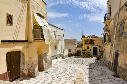 A small street between the old houses of Irsina, a village in the province of Matera in Italy.