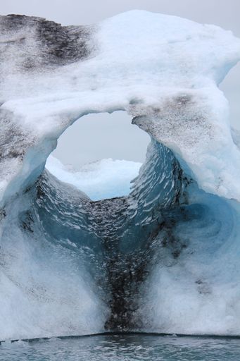 A vertical shot of a hole on the ice in Jokulsarlon, a glacial lake in Iceland.