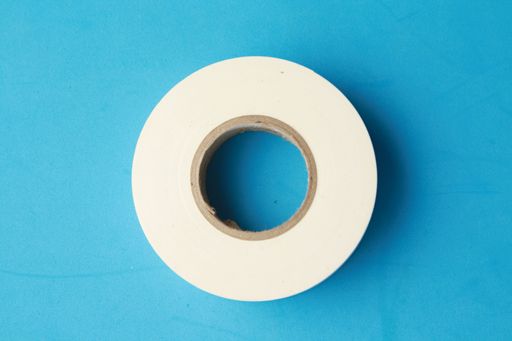 A top view of a white tape isolated on a blue background