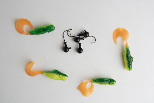 A top view of different fishing lures isolated on a gray surface